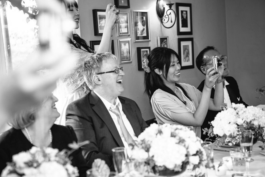 The guests watched as the bride and groom feed each other cake.