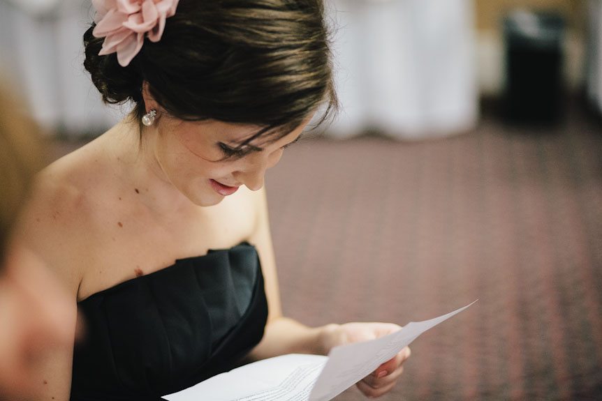 A bridesmaids reading a note she got from the bride at a Queen's Landing Hotel wedding.
