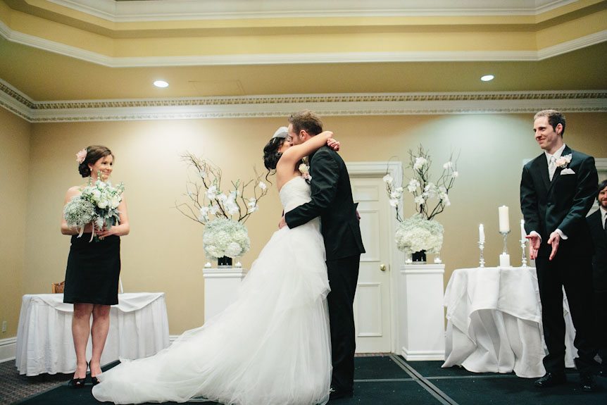The first kiss as newlyweds captured by a wedding photographer in Niagara-On-The-Lake.