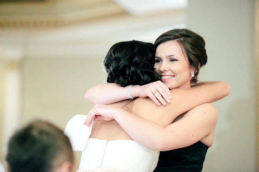 The bride and the maid of honour hug after the speech.