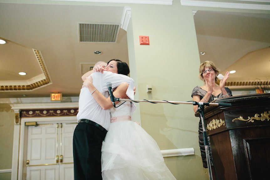 The bride hugs her father.