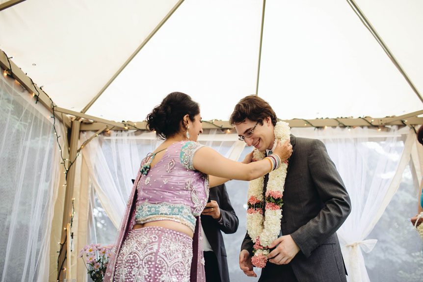 The bride and groom exchange garland as part of the Indian wedding tradition.