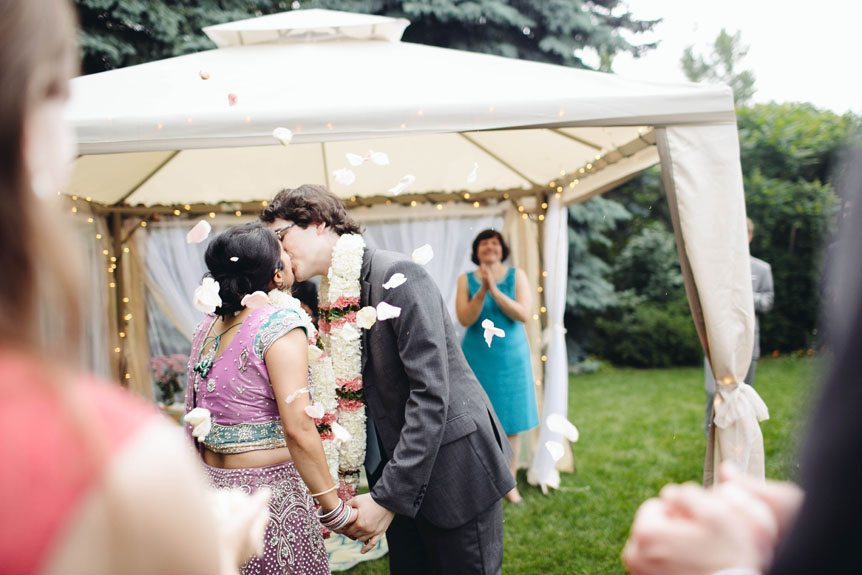 An Indian bride and a Czech groom share their first kiss.