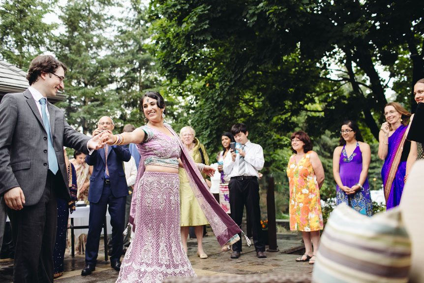 The bride and groom at an intimate backyard wedding in Toronto shares their first dance.