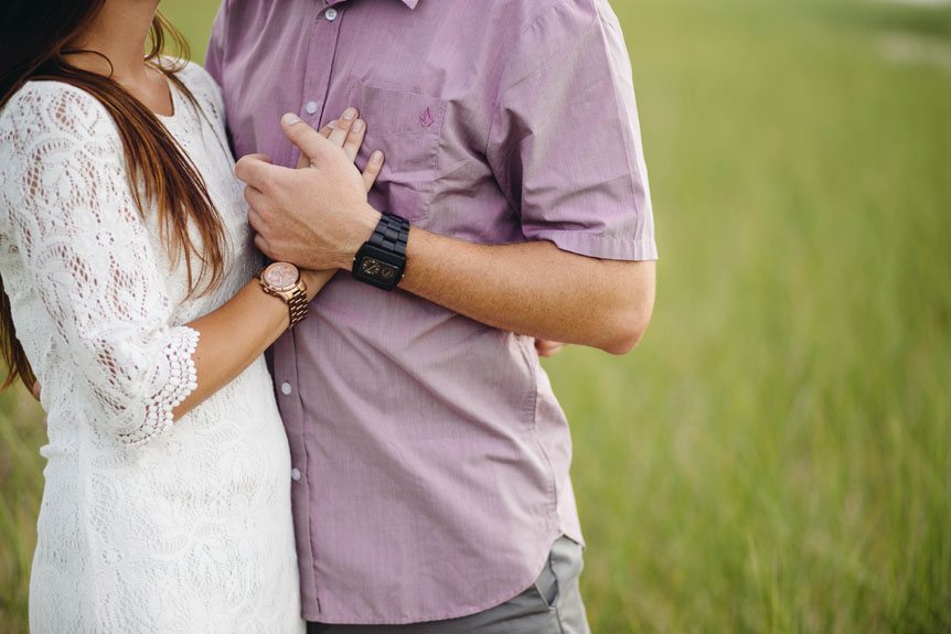 An engaged couple holding hands during their engagement session.