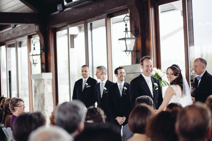 The bride and groom exchanges vows at an elegant Cambridge Mill wedding.
