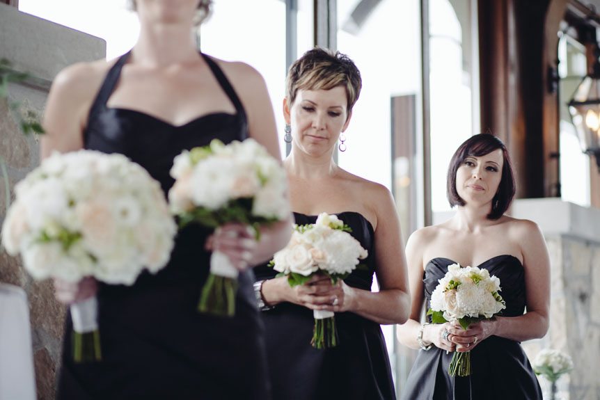 A stylish bridesmaid in black dresses at an elegant wedding at the Cambridge Mill.