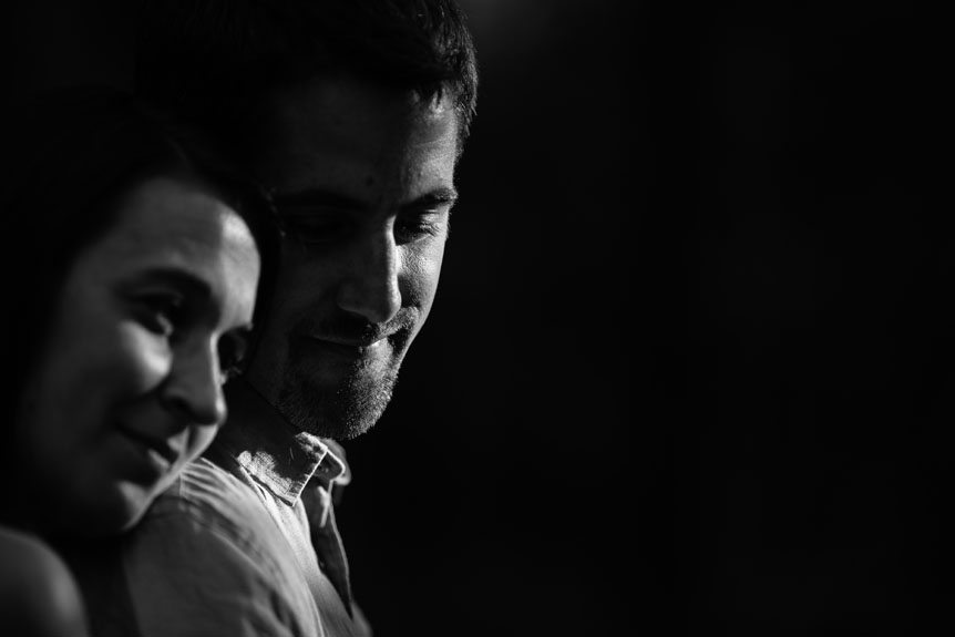 A dramatically lit portrait of an engaged couple taken by Lyn Ismael.