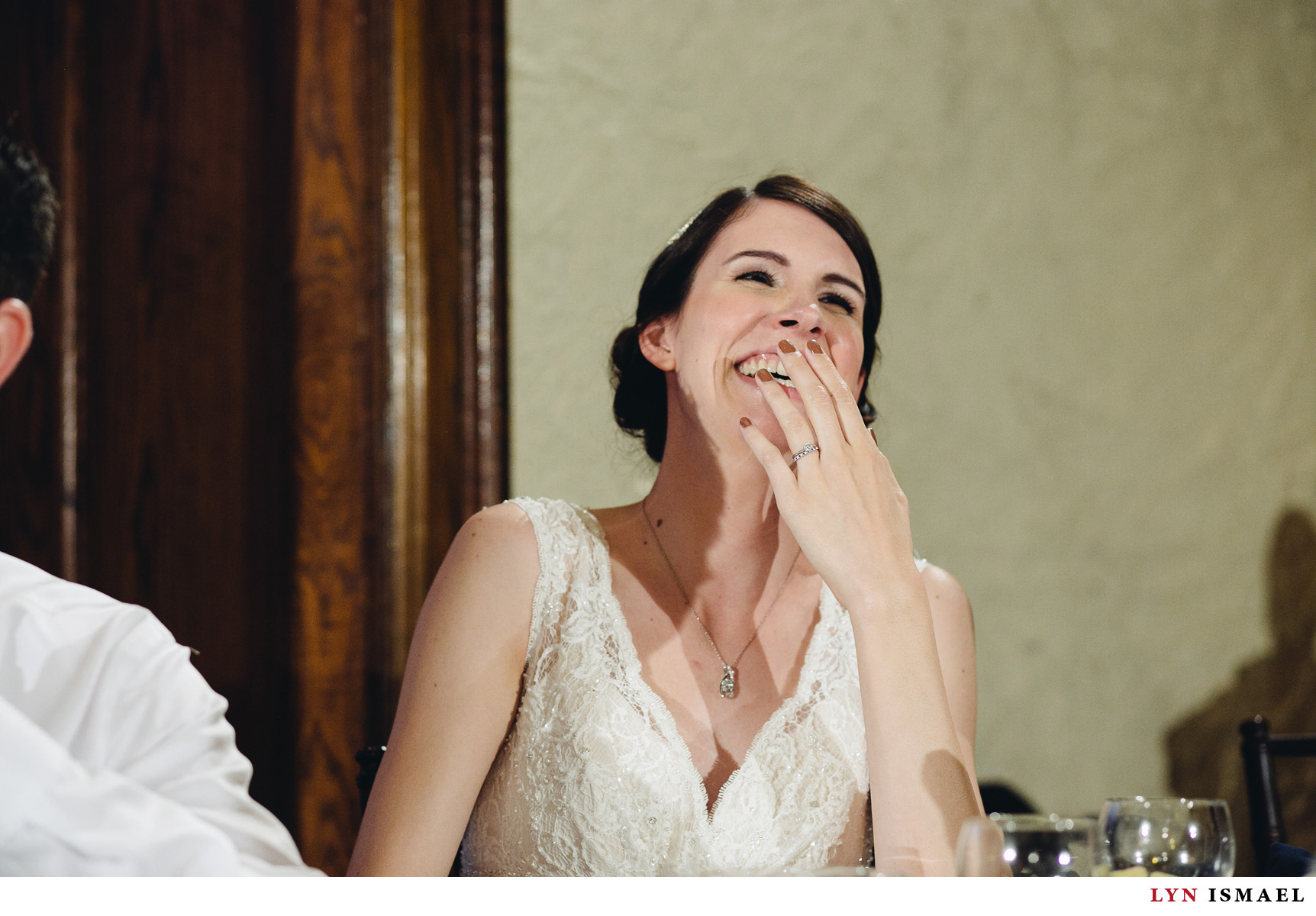 The bride laughs at her sister's stories of her.