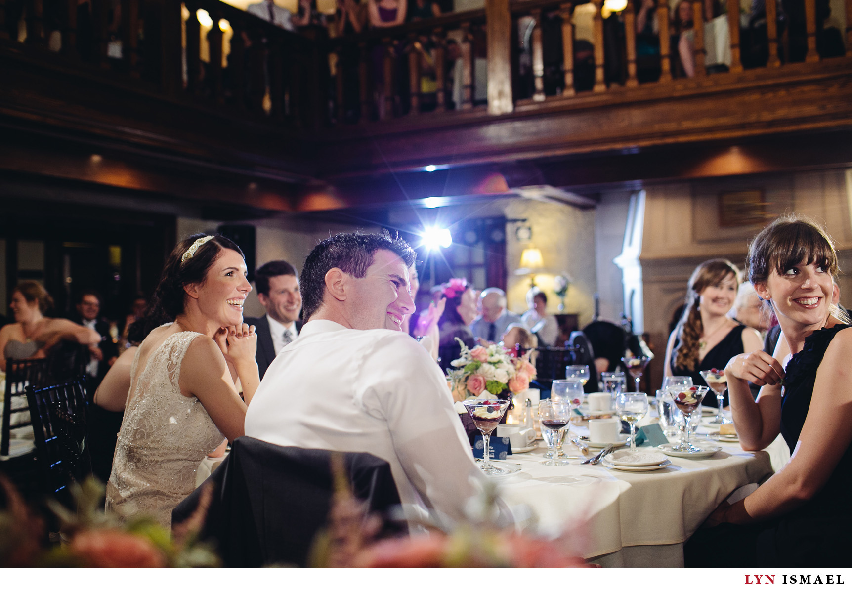 The bride and groom and their guests listen to speeches at the Windermere Manor wedding