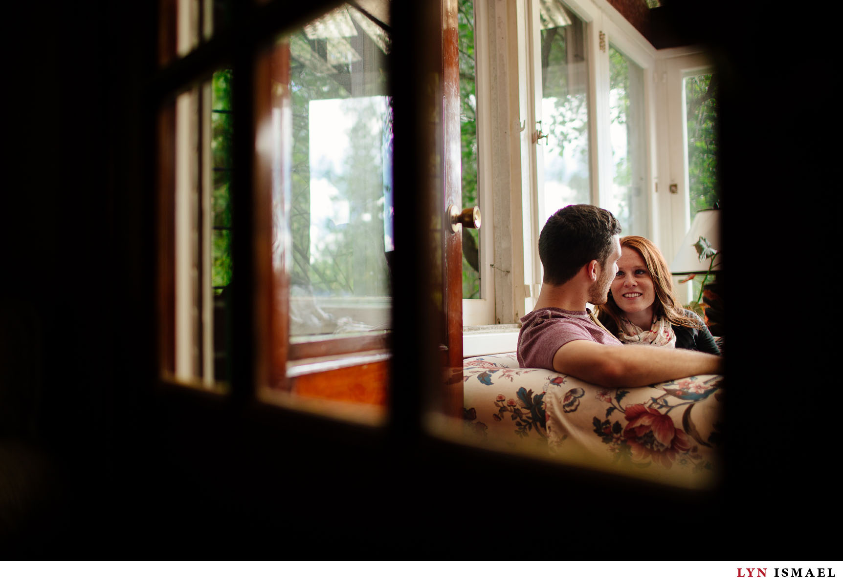 a couple relaxes in the sunroom.