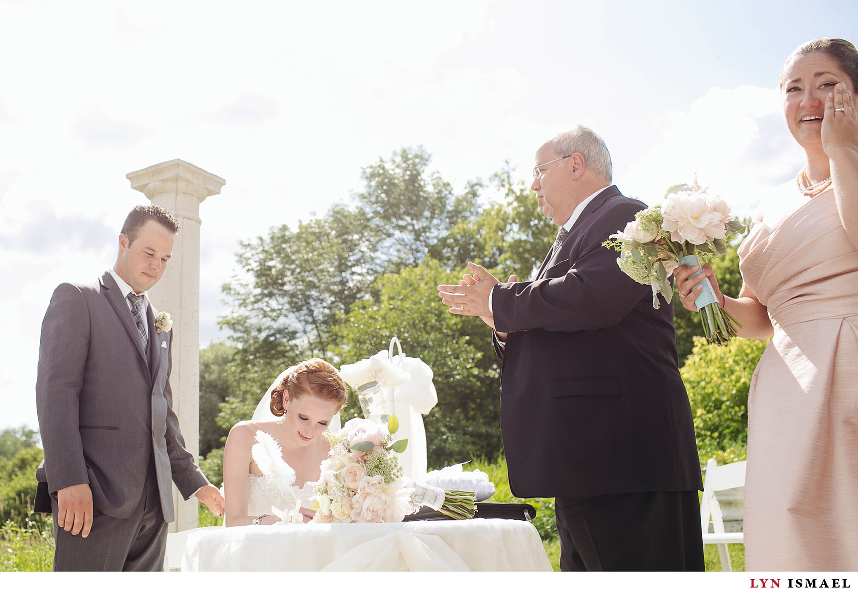 Beautiful bride and groom signs their marriage contract at a Nithrdige Estate Wedding.
