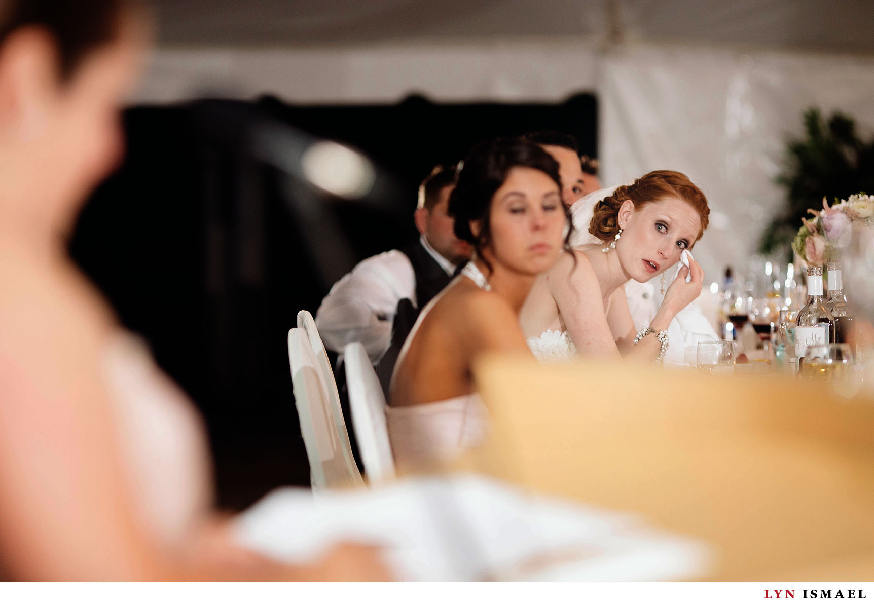 Redhead bride tears up listening to her Maid of Honor's speech.