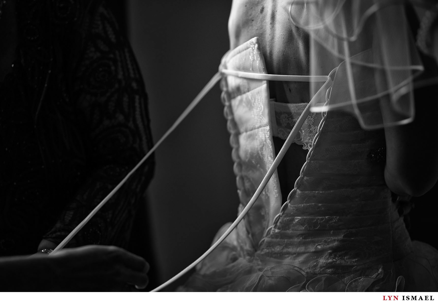 A dramatically lit image of the bride getting ready.