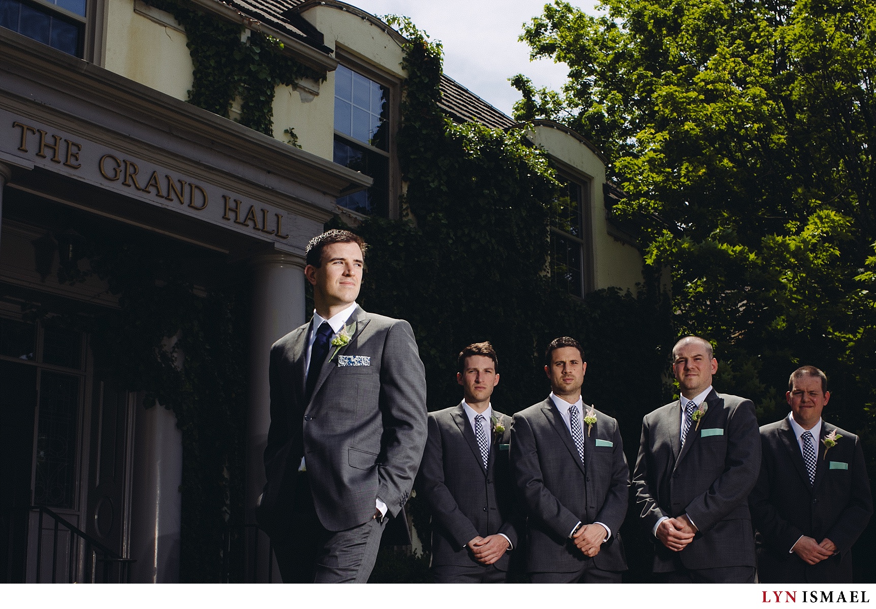 Creatively lit portrait of the groom and his groomsmen