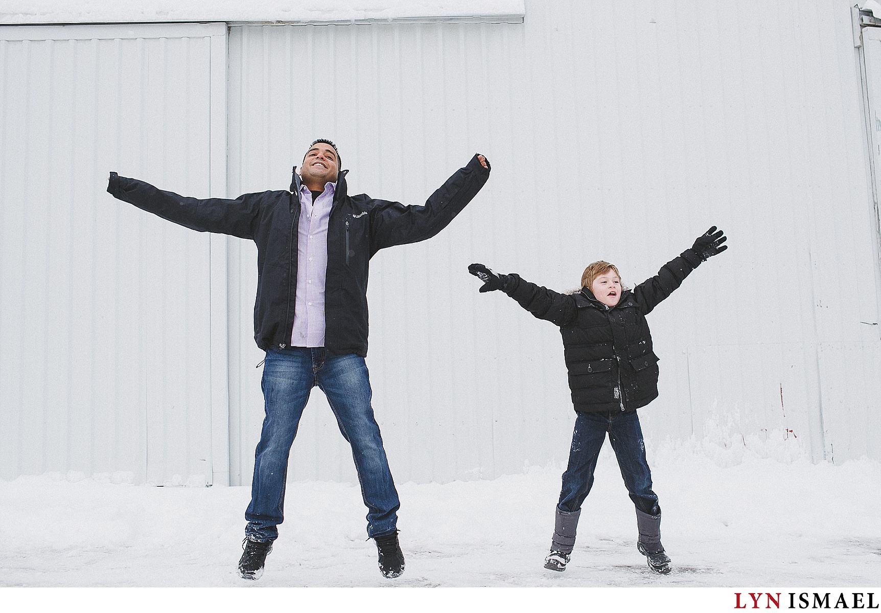 Father and son does jumping jacks at an engagement session in Schomberg.