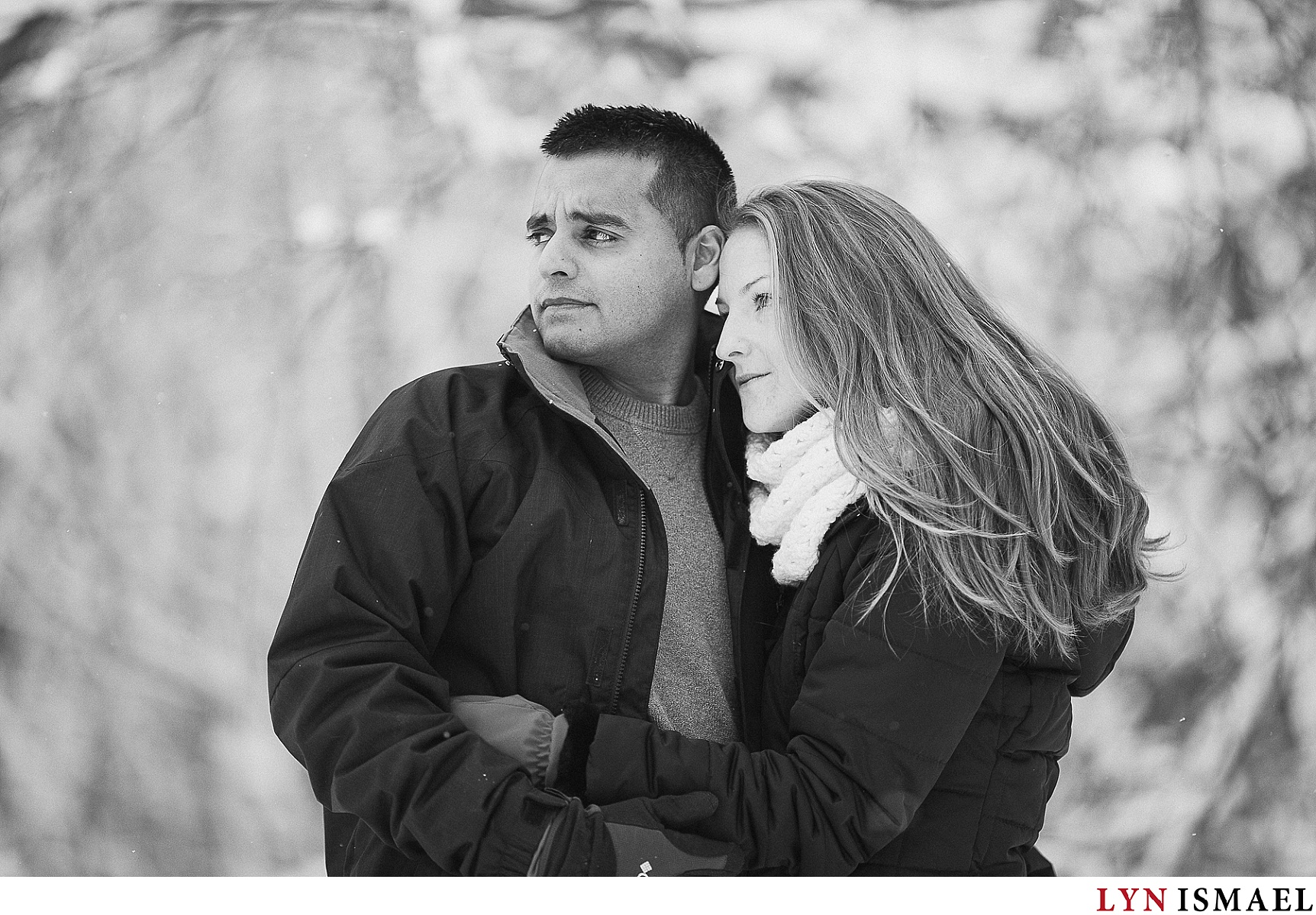A black and white portrait of an engaged couple.