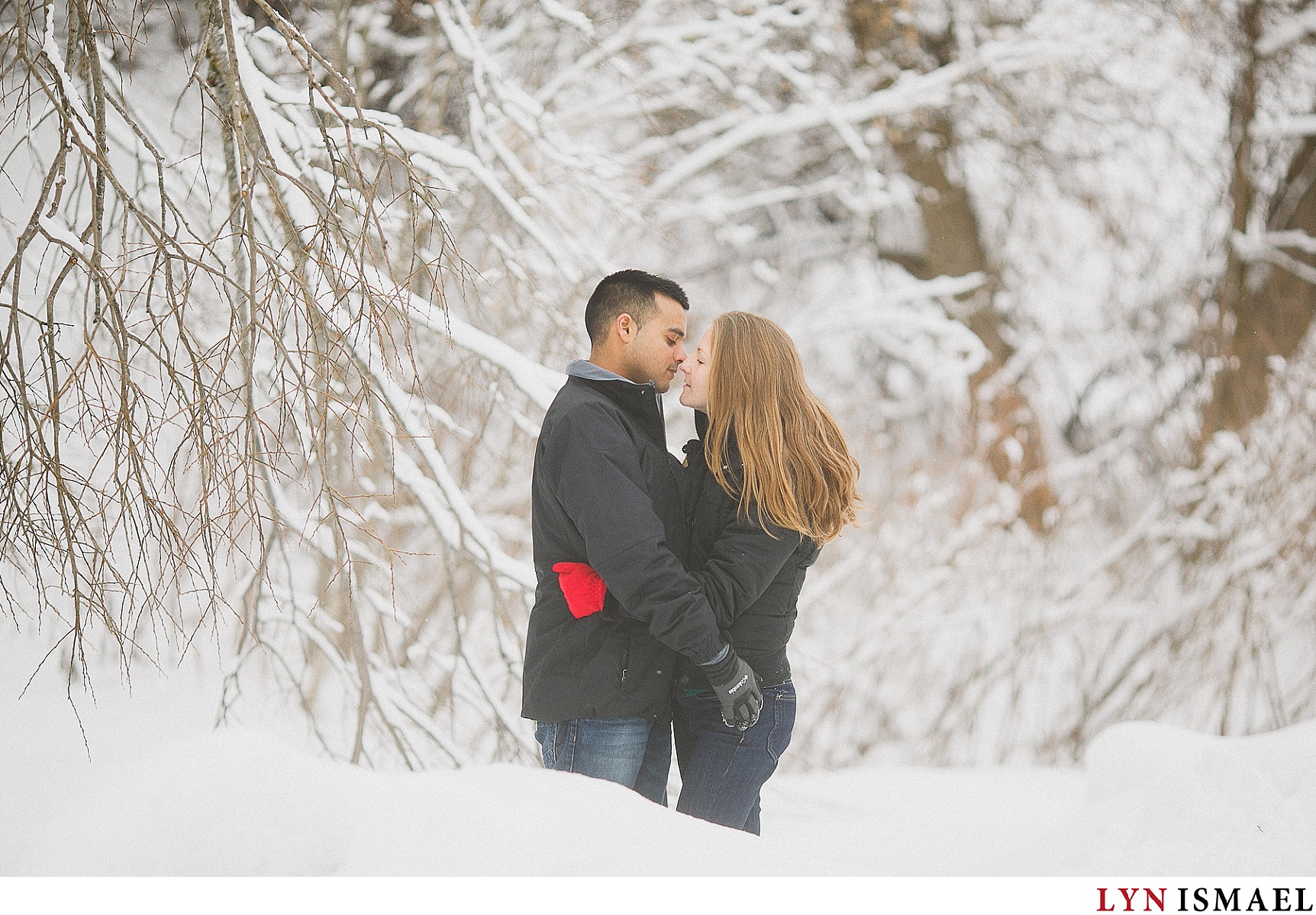 Couple kissing outside in the winter.