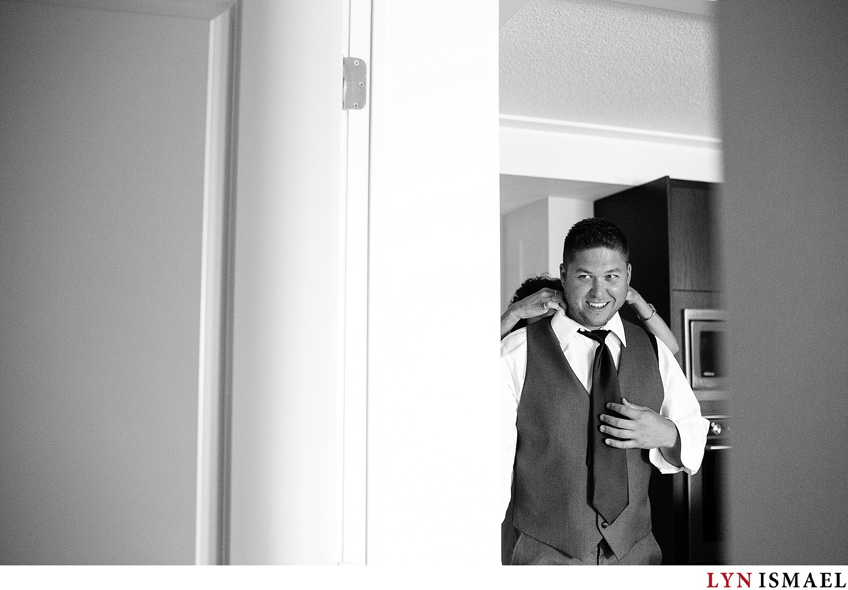 black and white image of the groom getting ready.