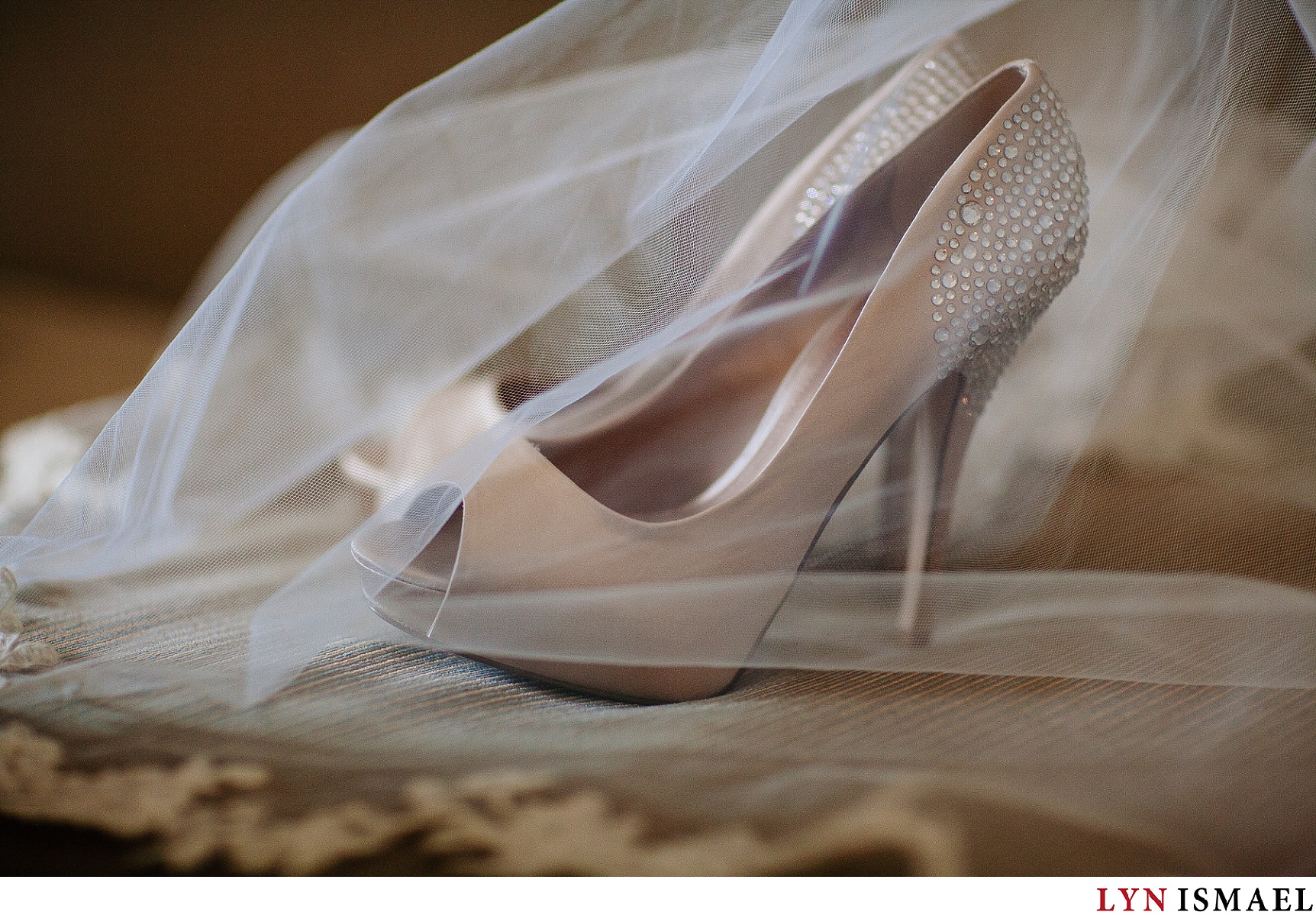 shoes of the bride covered by her veil.