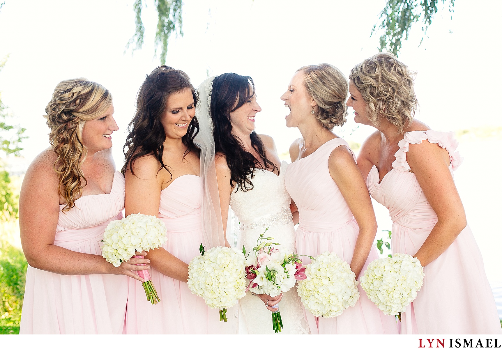Bridesmaids wearing pink dresses.