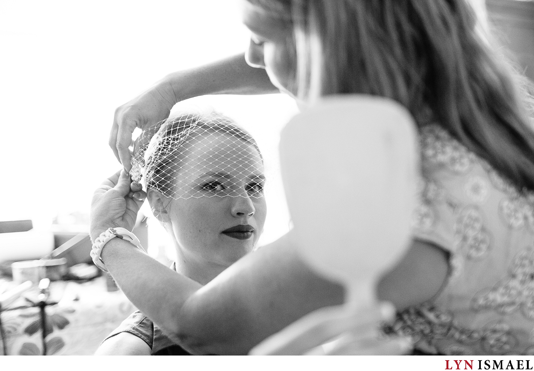 bride looks at herself in the mirror