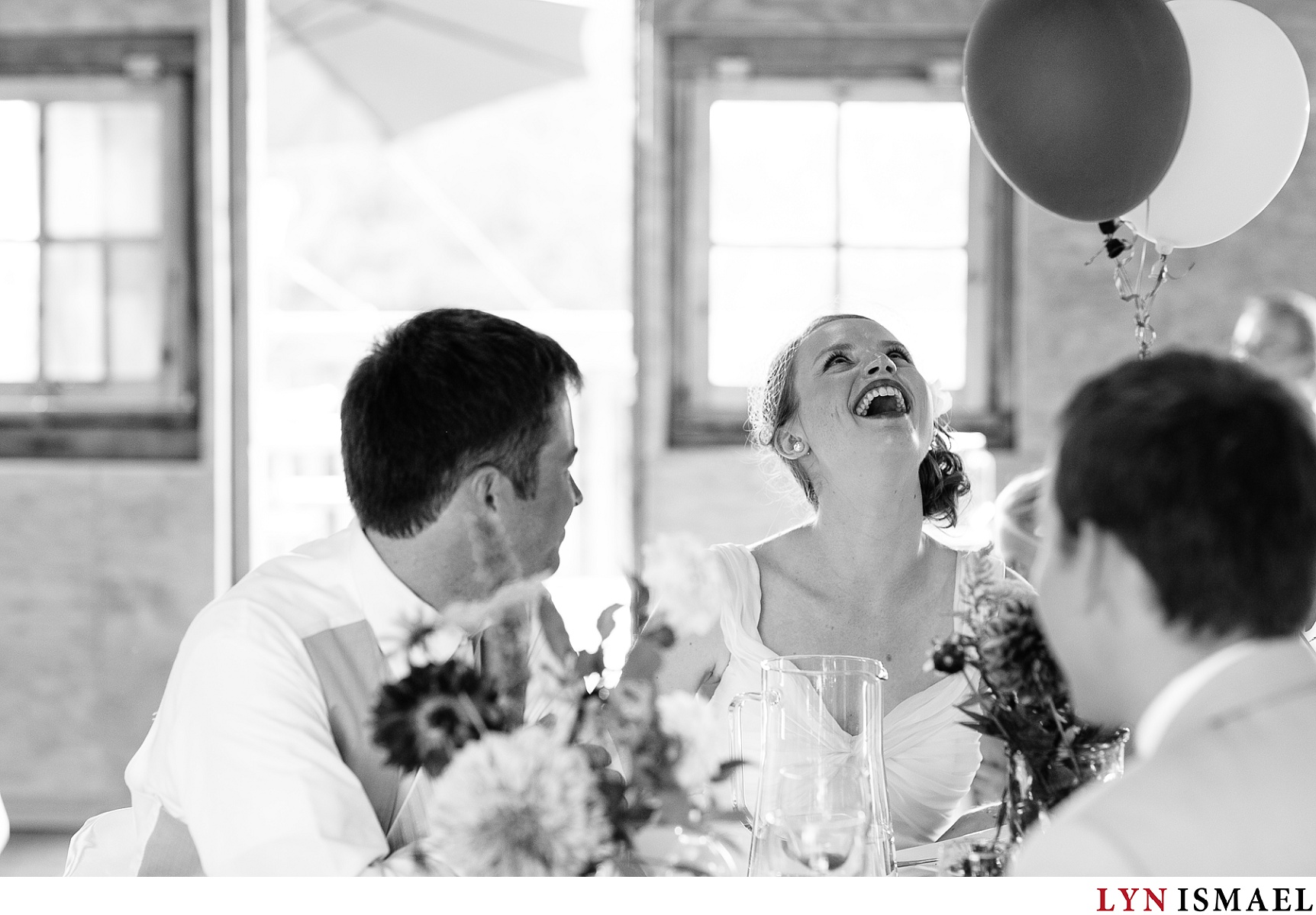 the bride laughing at her reception at the Hampton Barn