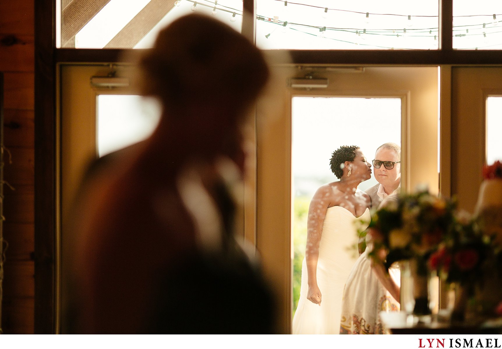 Bride and groom shares a kiss before they enter the reception room at a Holland Marsh Wineries wedding.
