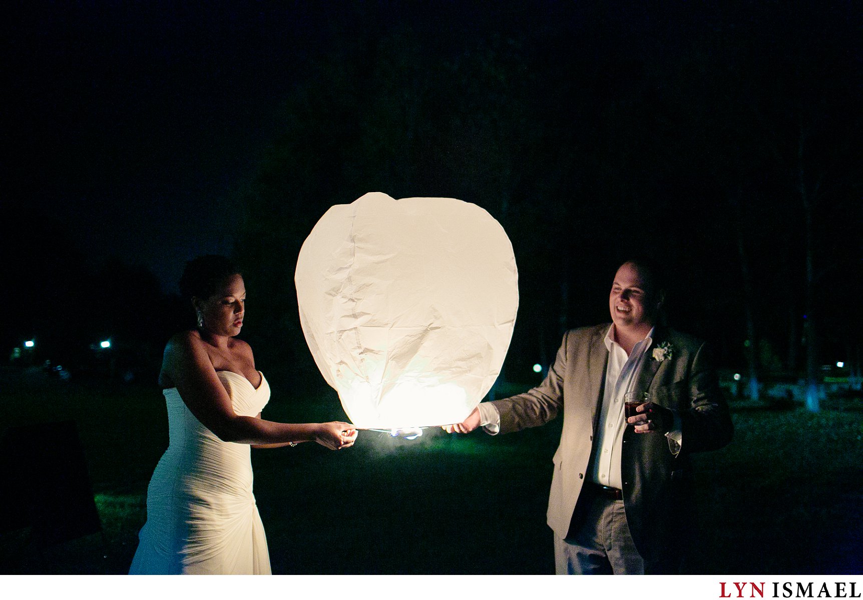Bride and groom lights up a lantern at a Holland Marsh Wineries wedding.