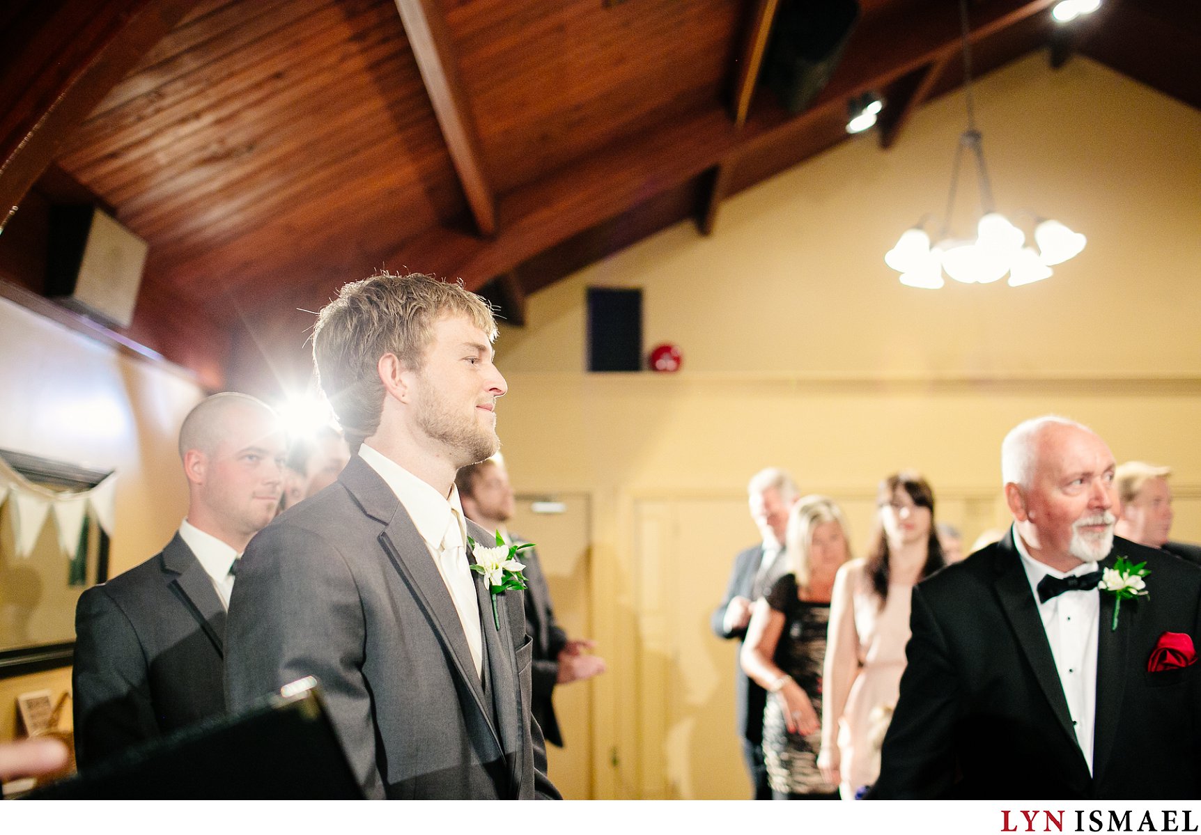 The groom watches as his bride walks down the aisle.