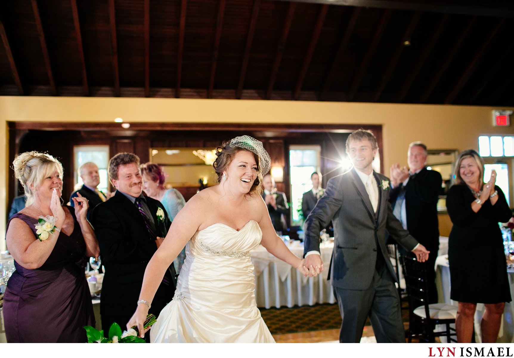The bride and groom are welcomed by their guests at their Cutten Fields wedding reception.