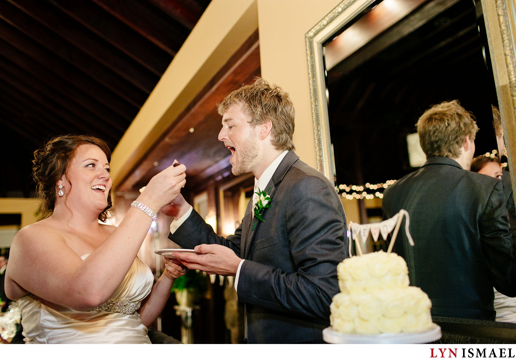 The bride and groom eats their cake.