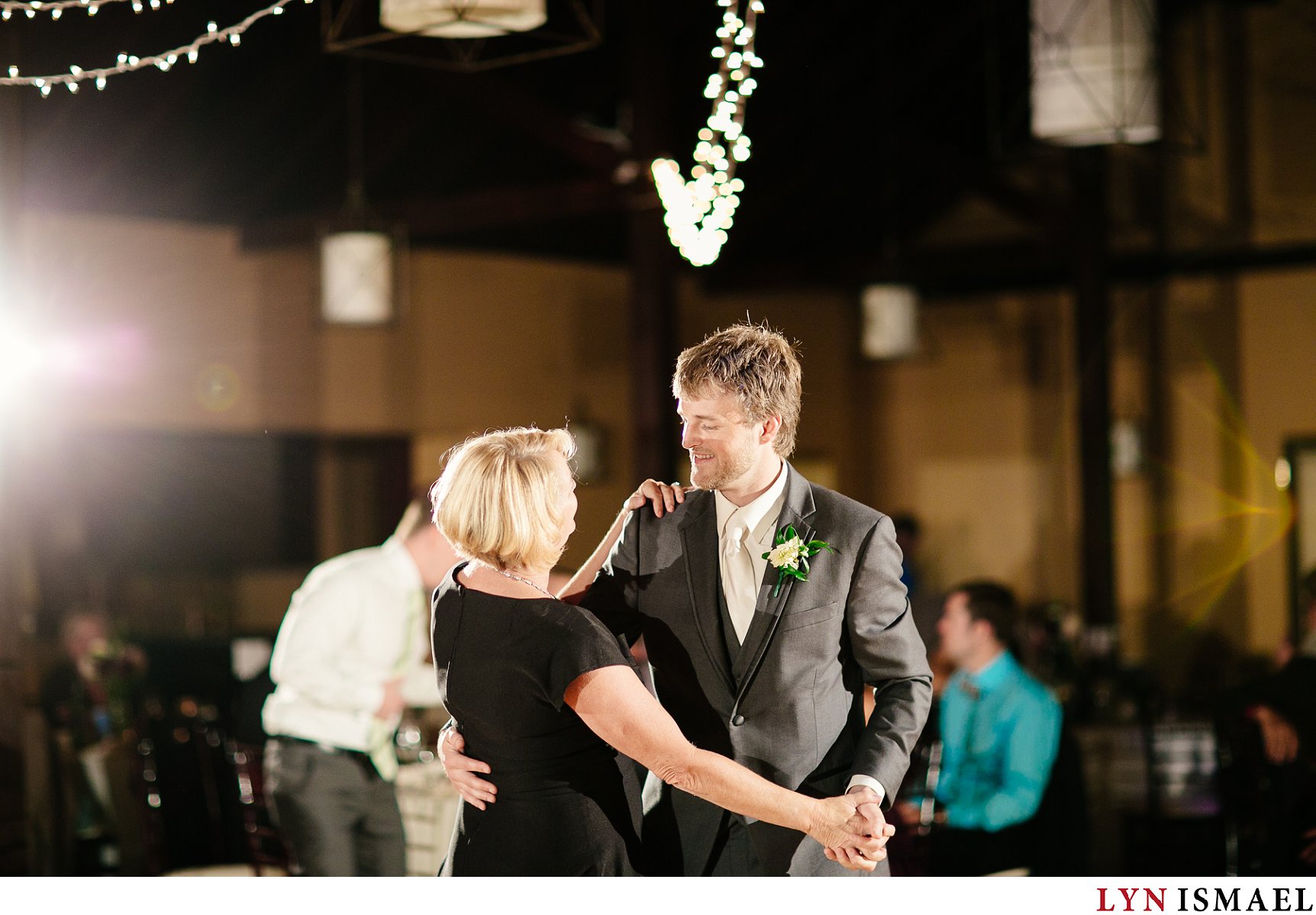 The groom dances with his mom.