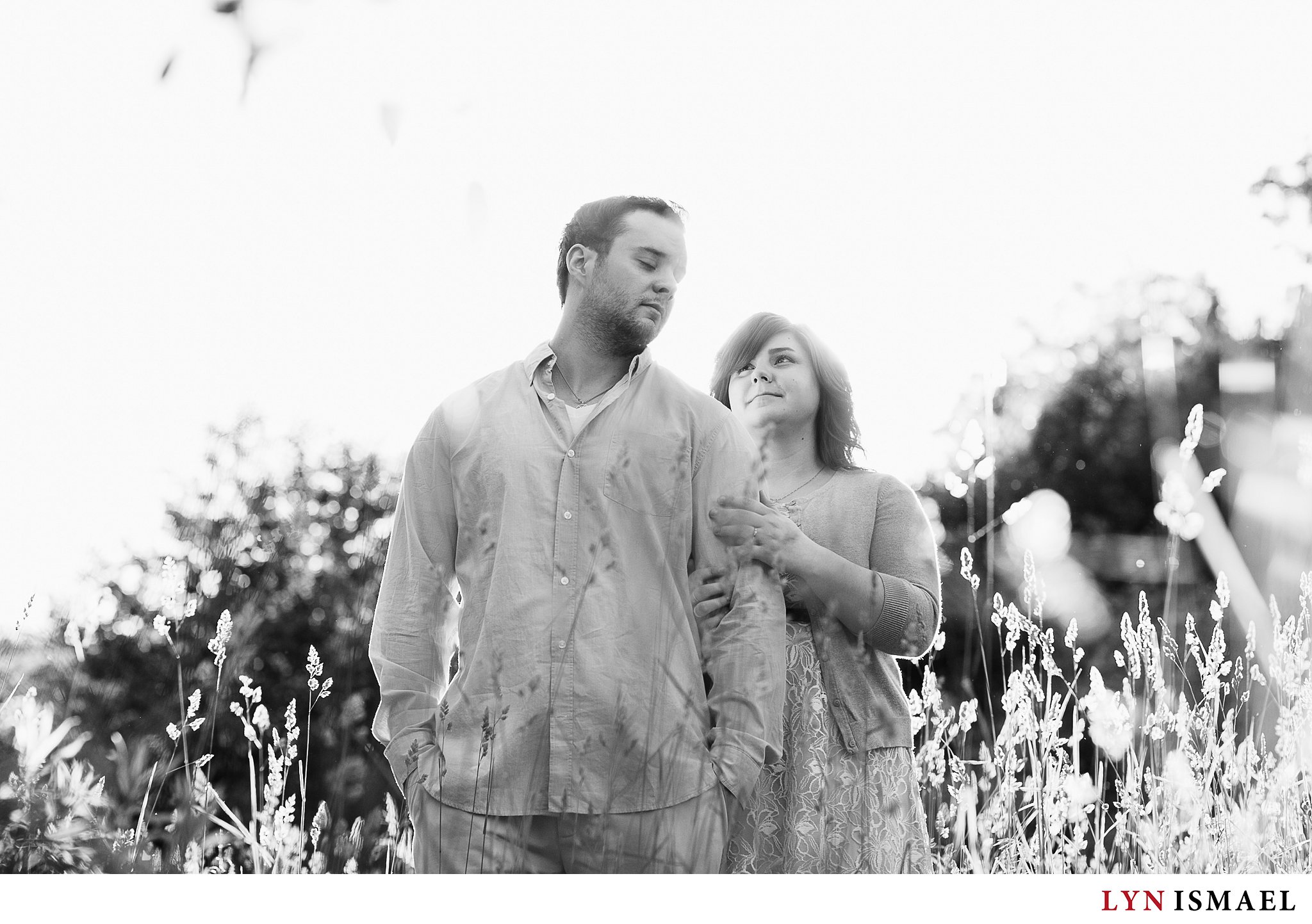 A black and white portrait of a newly engaged couple.