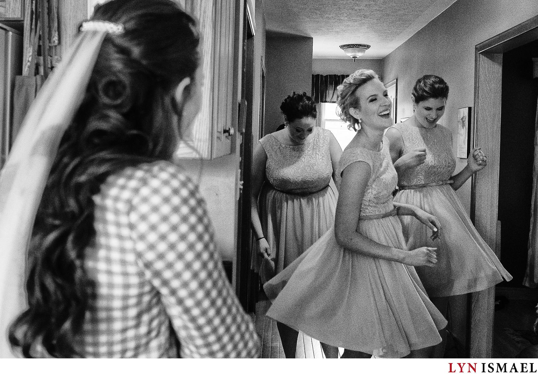 Bridesmaids twirl to show off their bridesmaid dresses