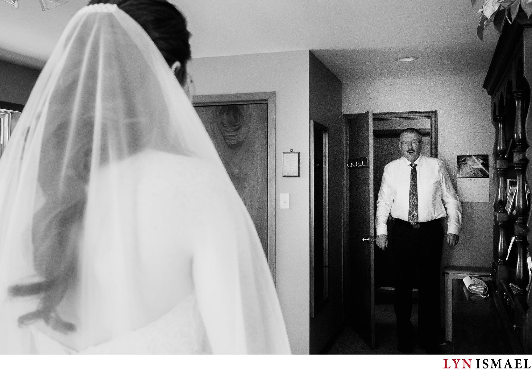 Father of the bride sees his daughter for the first time as a bride