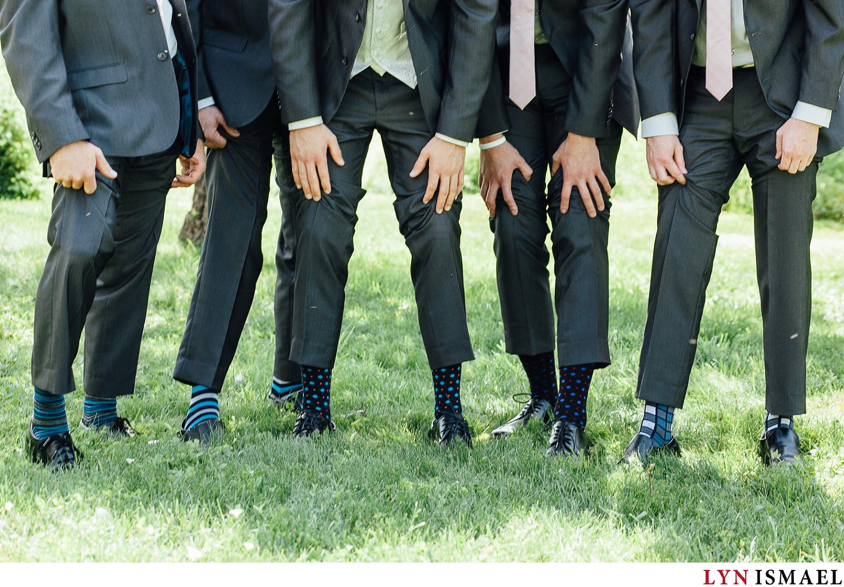 Groom and his groomsmen show off their socks.
