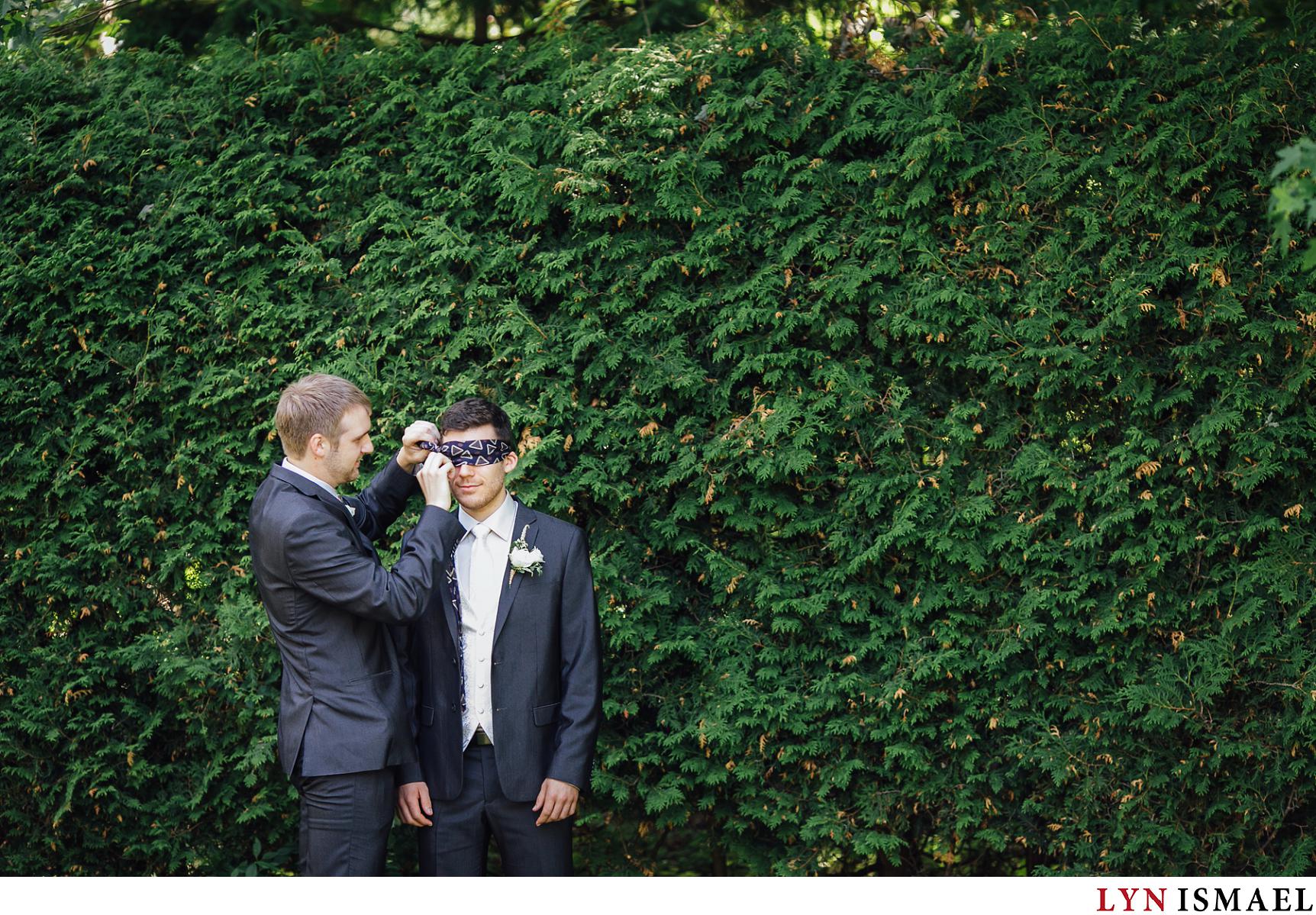 Groom's eyes get covered so he could talk to his bride before the wedding.