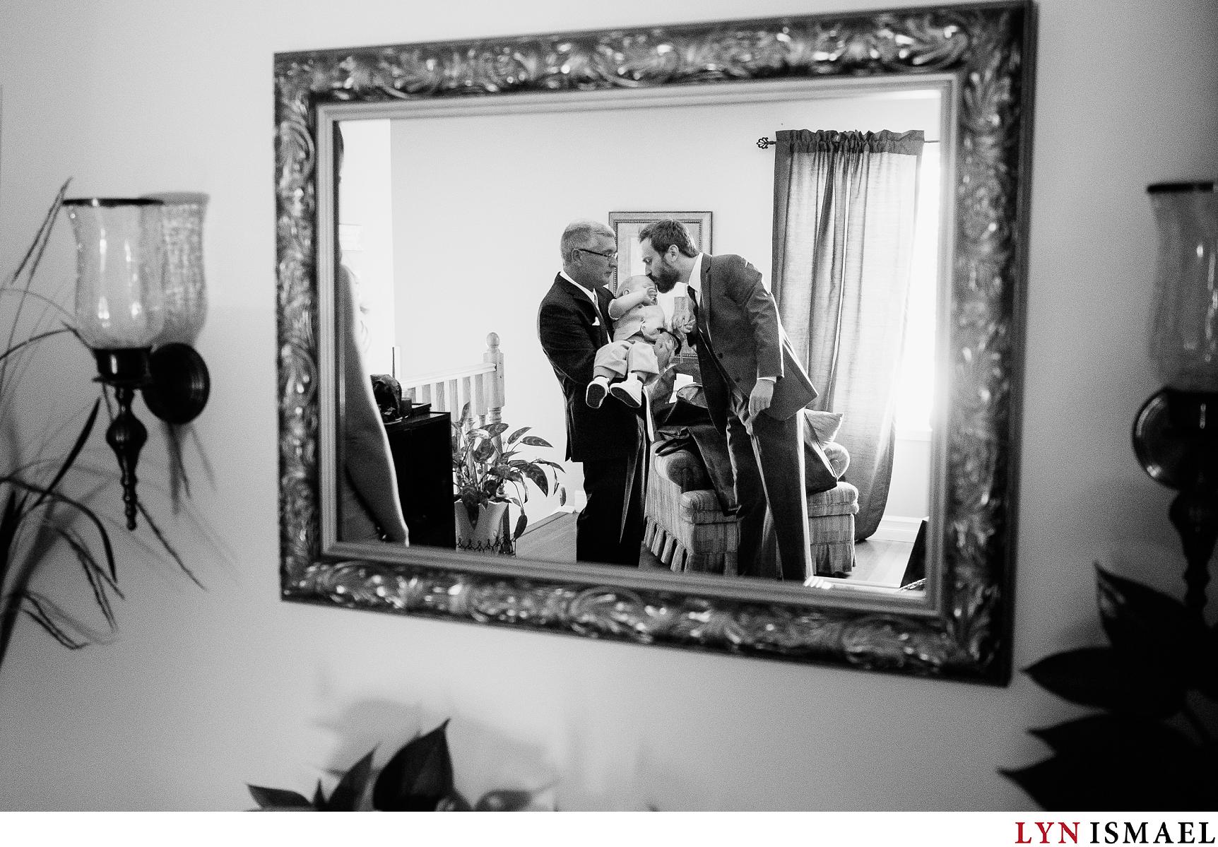 Groom kisses his son as he gets ready before his wedding ceremony in Waterloo Region