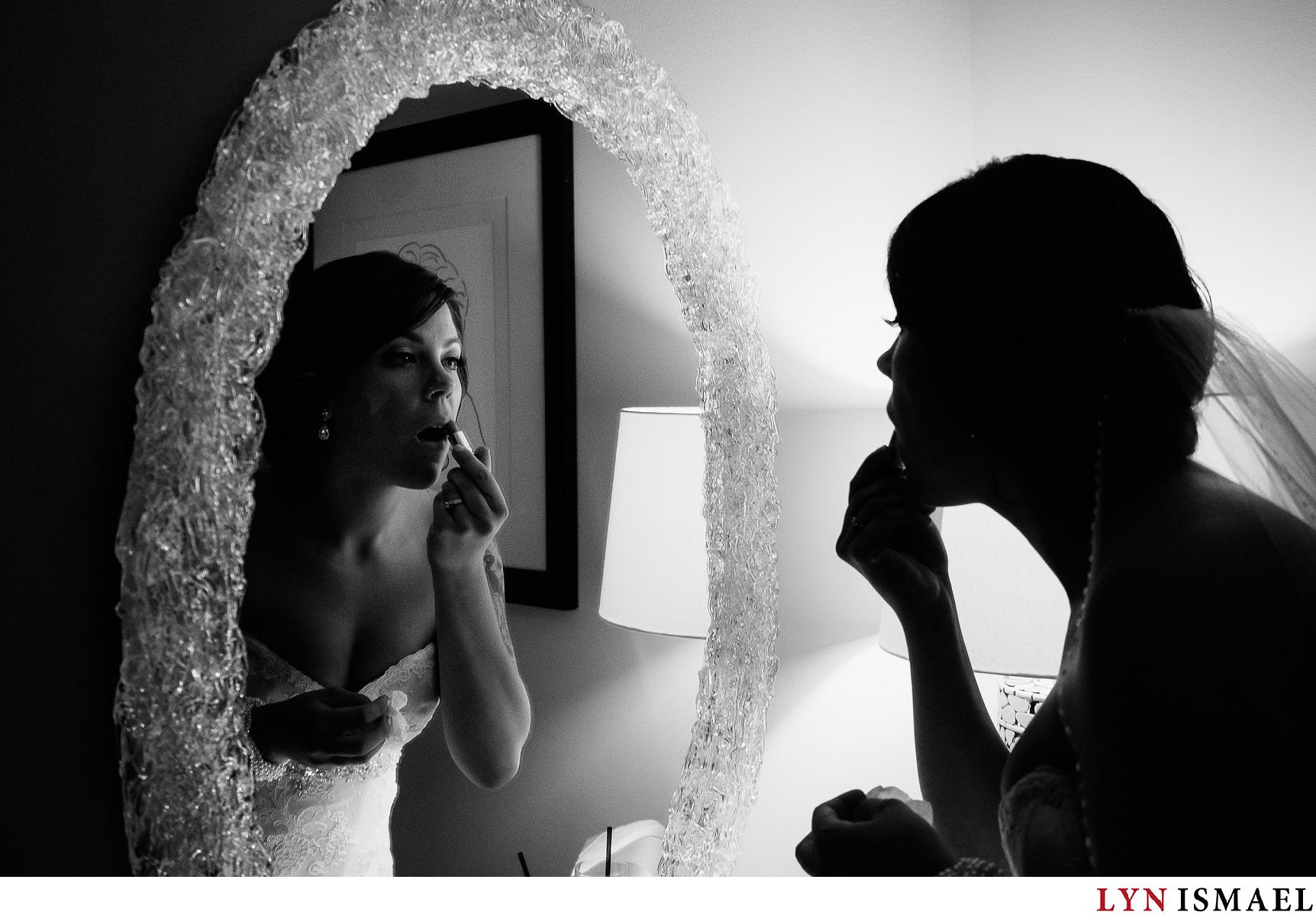 A bride applies her lipstick
