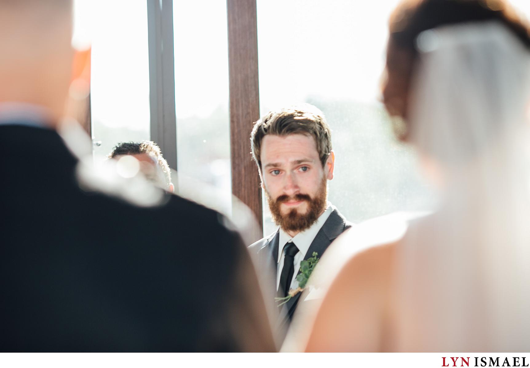 Groom becomes emotional as he watches his bride walk down the aisle.