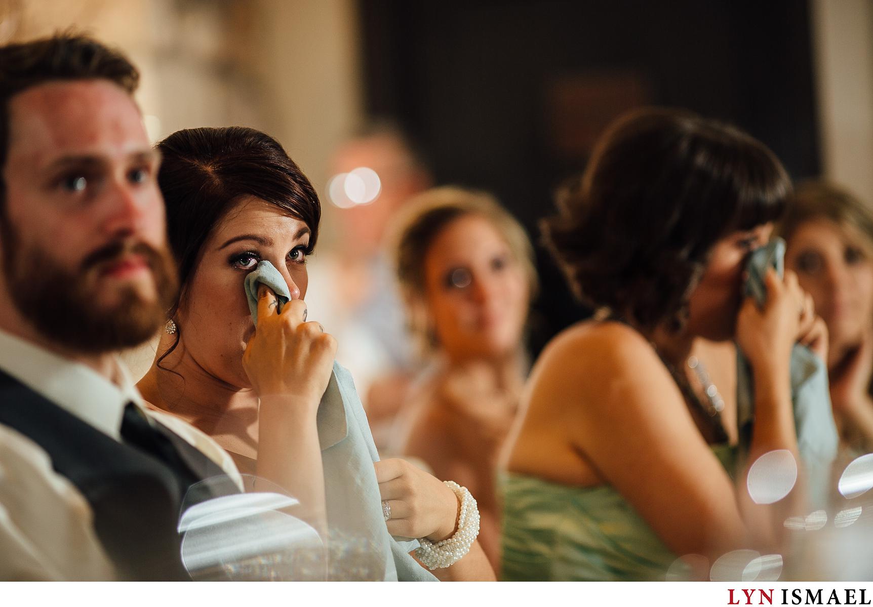 Maid and honour and the bride wipe their tears at the same time at a Waterloo Region wedding.