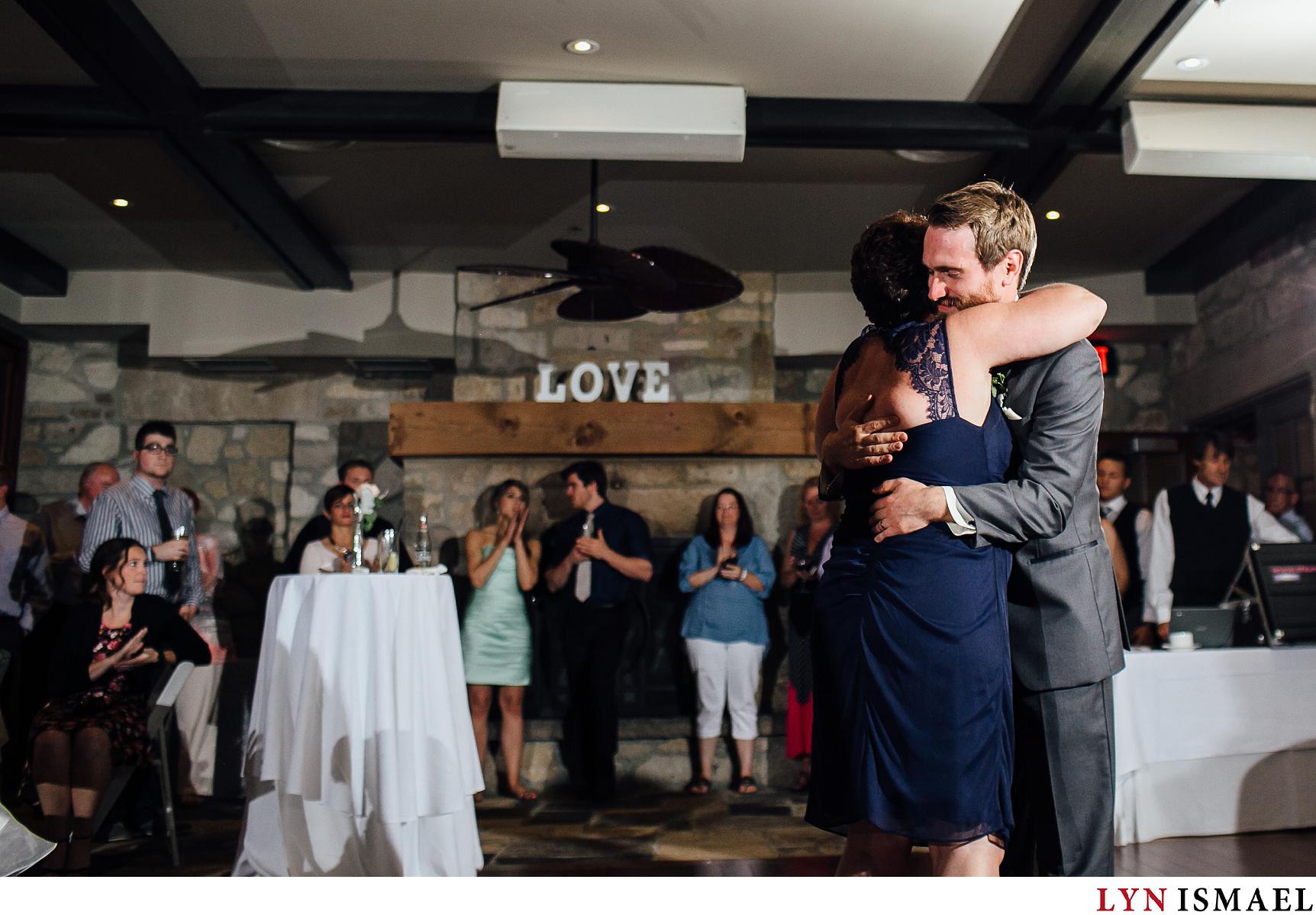 Groom hugs his mom after the son-mother dance at a Waterloo Region wedding.