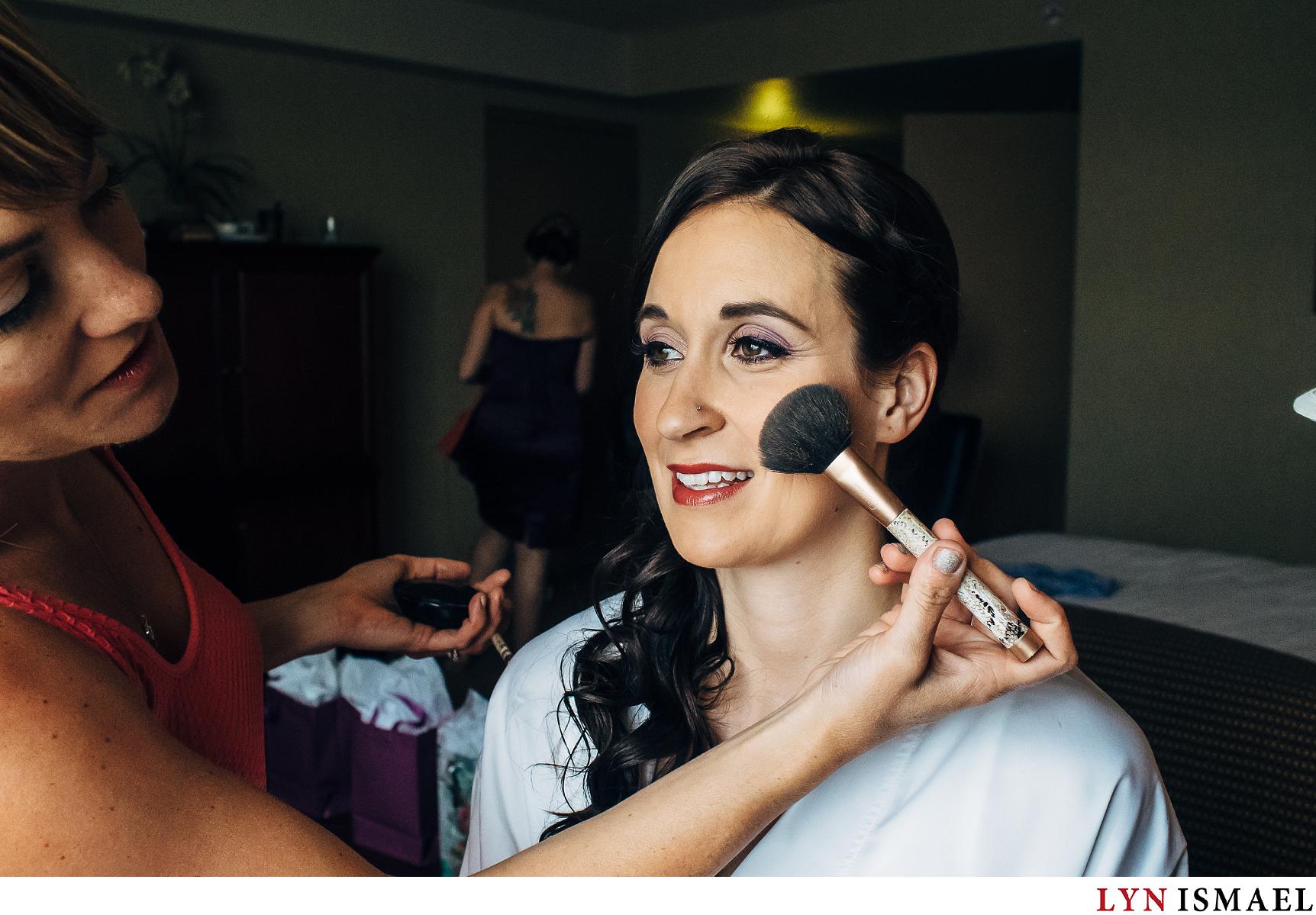 A bride has her makeup on