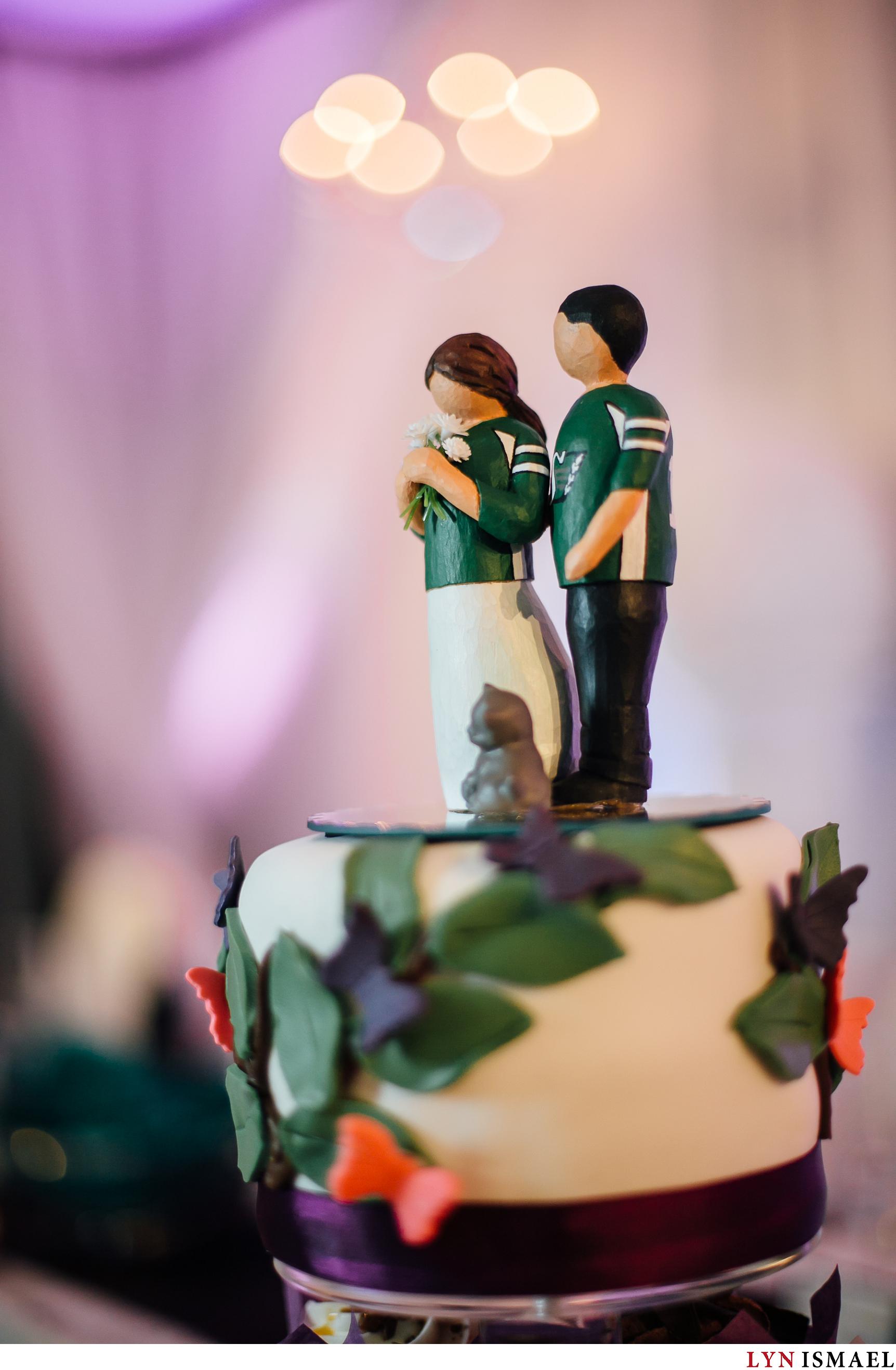 Cake topper featuring a bride and groom wearing Roughriders jersey