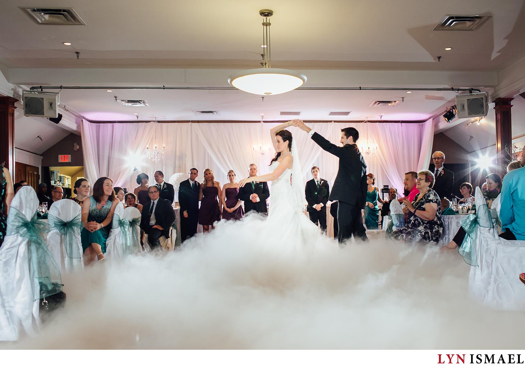 groom twirls his bride during their first dance