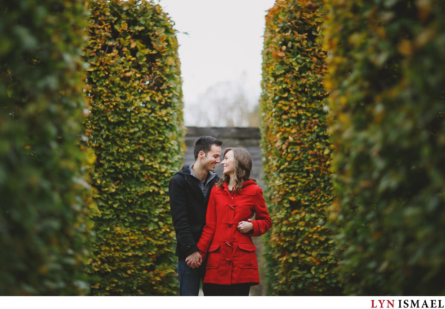 A couple at the University of Guelph's Arboretum poses in front of a modern Guelph photographer for their engagement photos