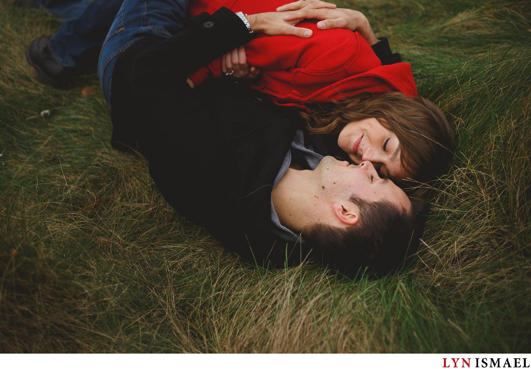 A couple cuddling in the field photographed by a modern Guelph photographer