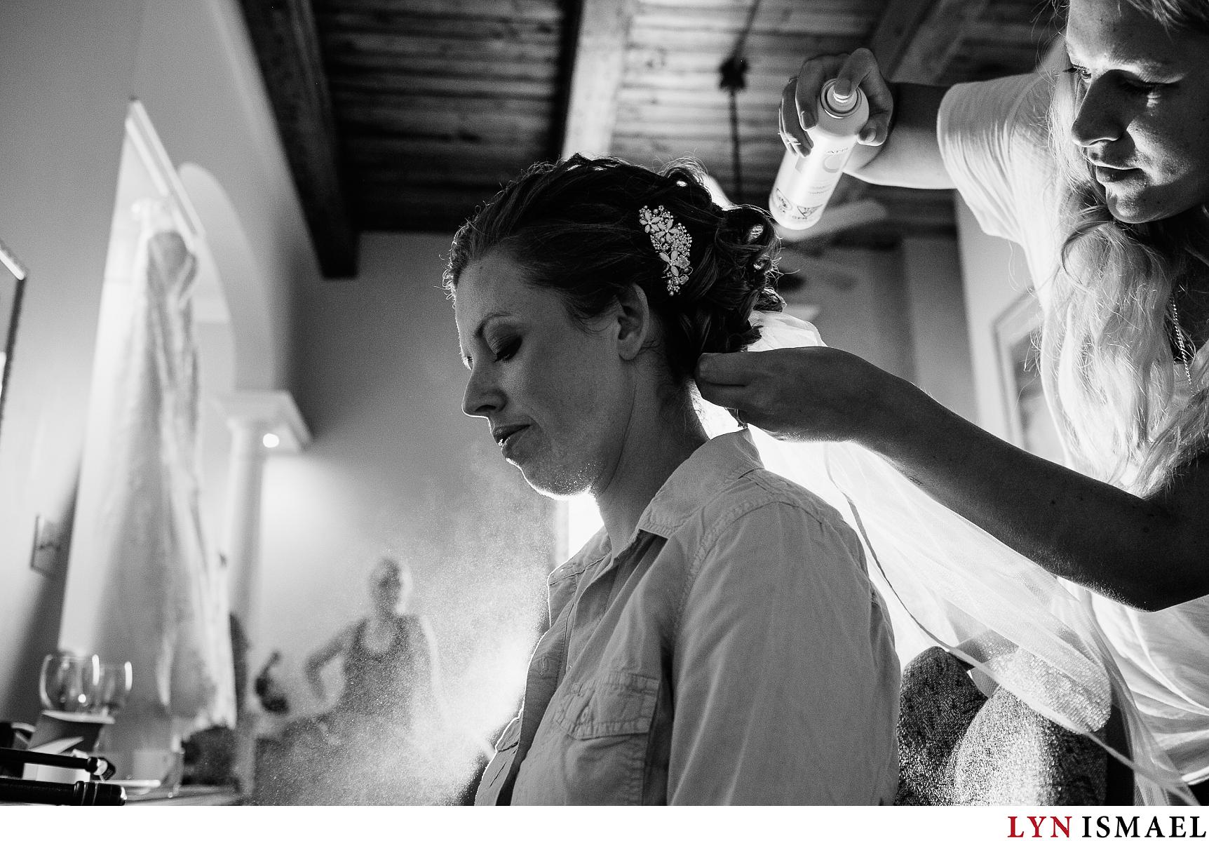 A bride gets her hair done before her wedding ceremony.