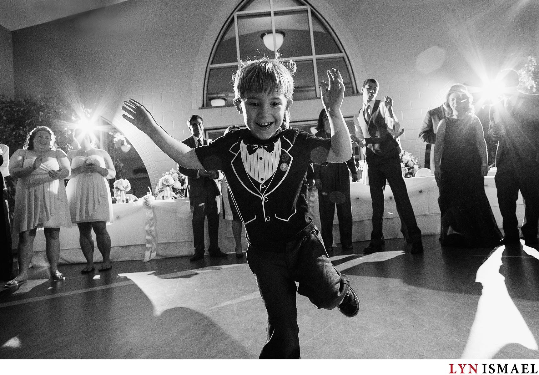 Little boy dancing at a Stoney Creek wedding reception.